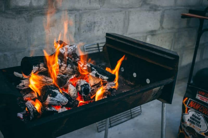 charcoal bbq with white hot wood and briquettes