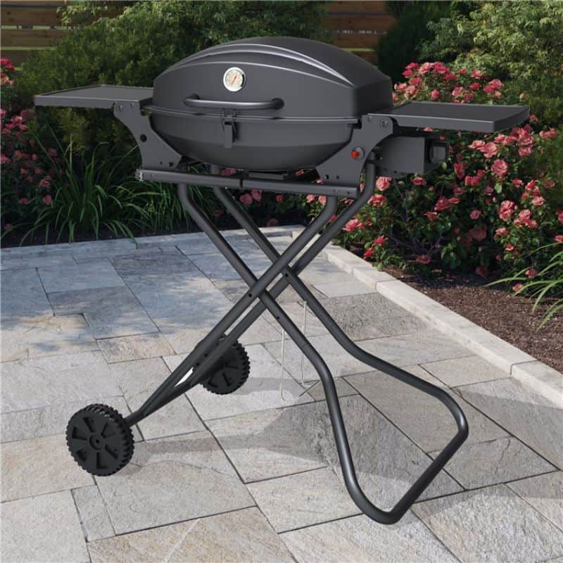 BillyOh Tennessee portable black tabletop BBQ on wheels on a patio with flowers